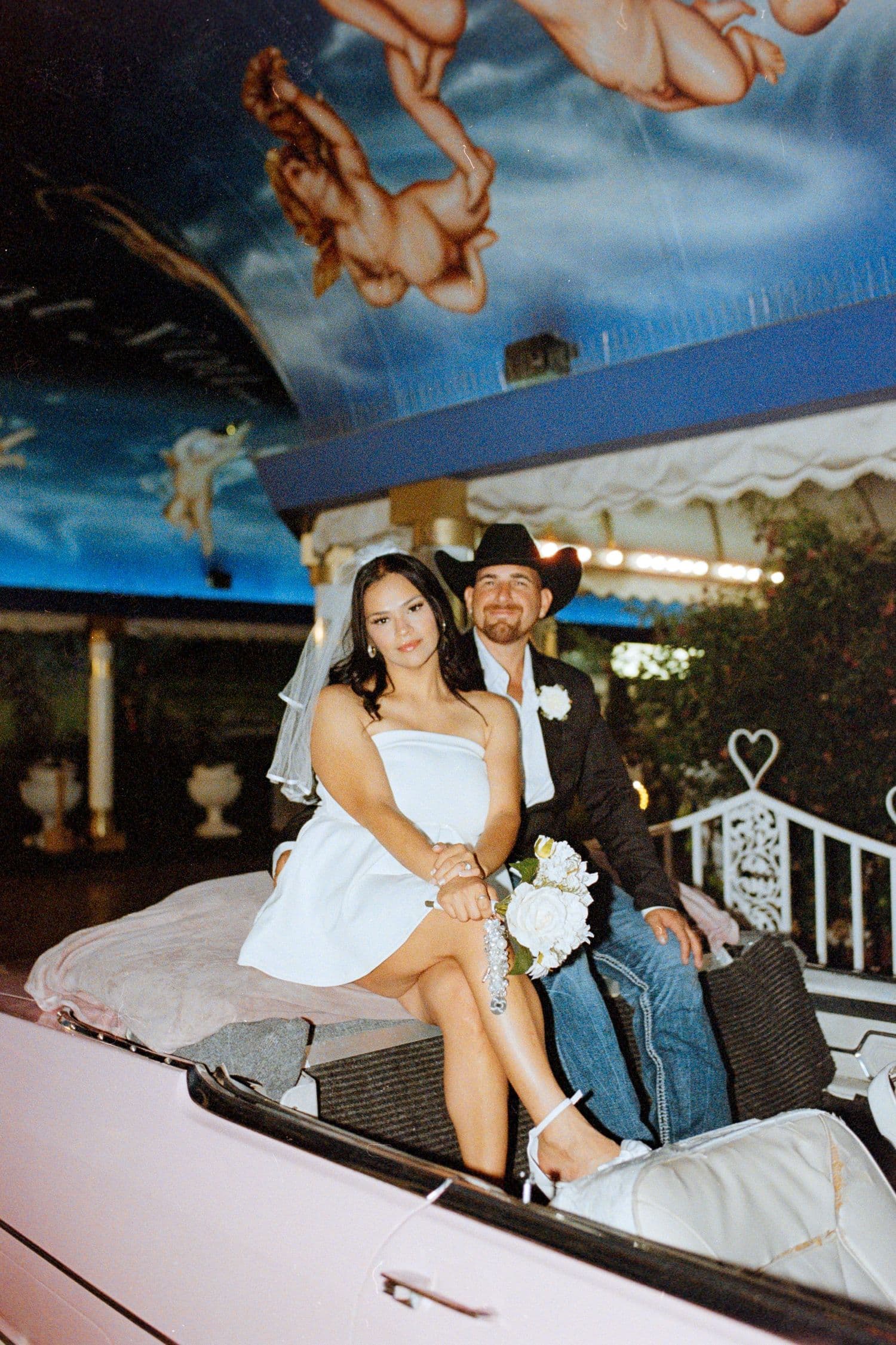 Newlyweds in the back of a vintage car