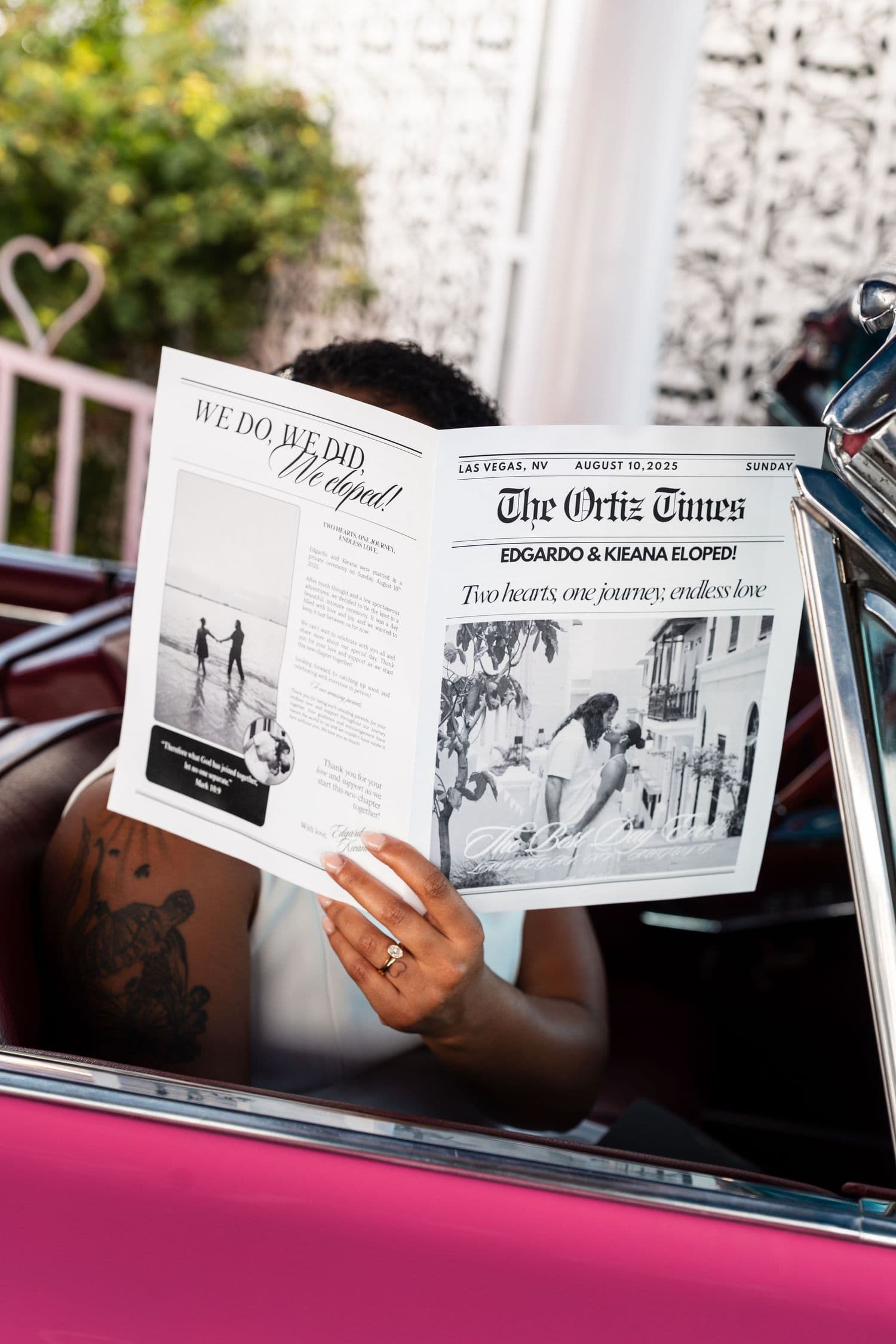 Couple reading newspapers in the pink car